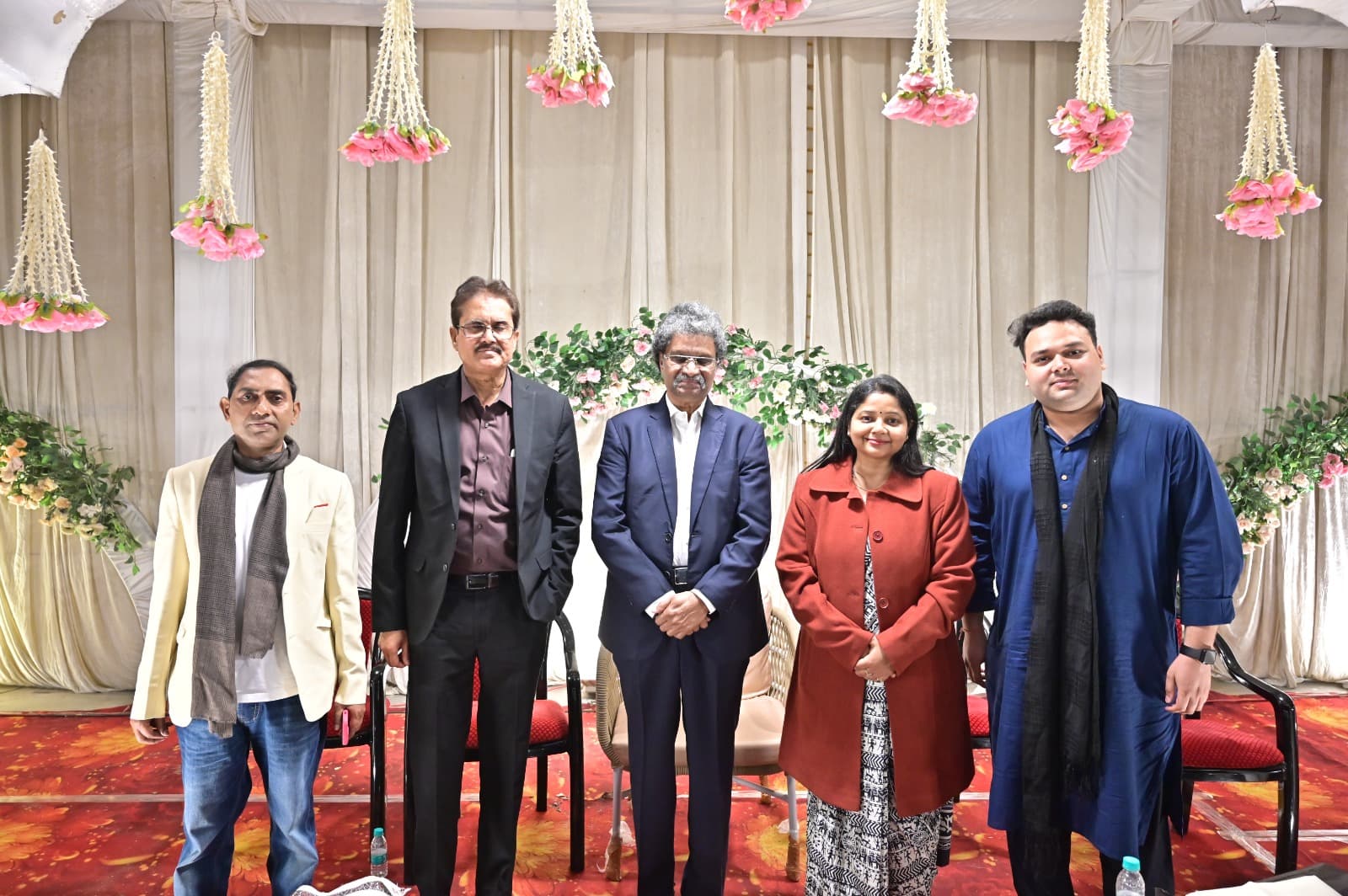 Poetry event speakers and organisers posing on stage at Adarsh Vatika